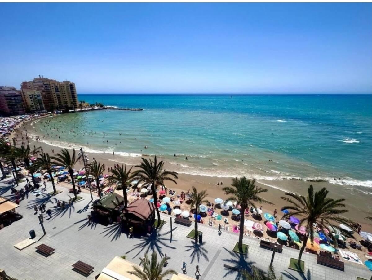 Playa del Cura seen from above, with palm-lined promenade and turquoise water