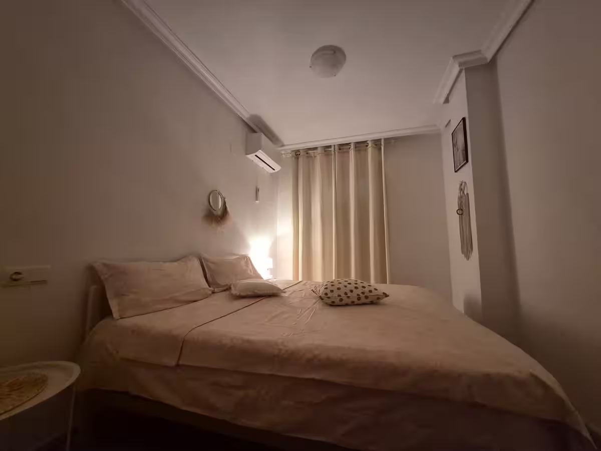 First bedroom with a double bed and air conditioning