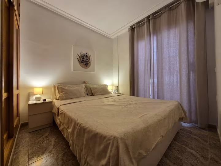 Second bedroom with a double bed, bedside lamps and a wardrobe