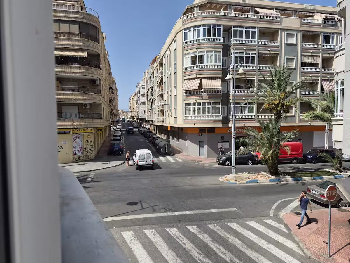 View from the apartment window over the street corner below
